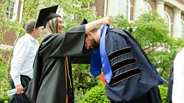 Shannon Brobst giving her Stole of Gratitude to an Economics Professor at Commencement.